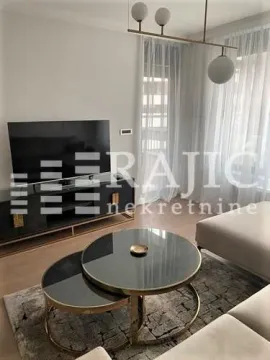 Modern and bright living room with a sofa and television. - image 7