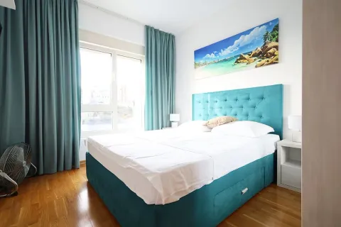 Bright and tidy bedroom with a turquoise double bed. - image 12