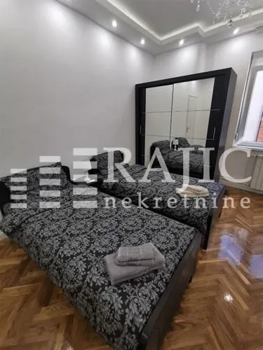 Bedroom with two single beds and a large wardrobe.