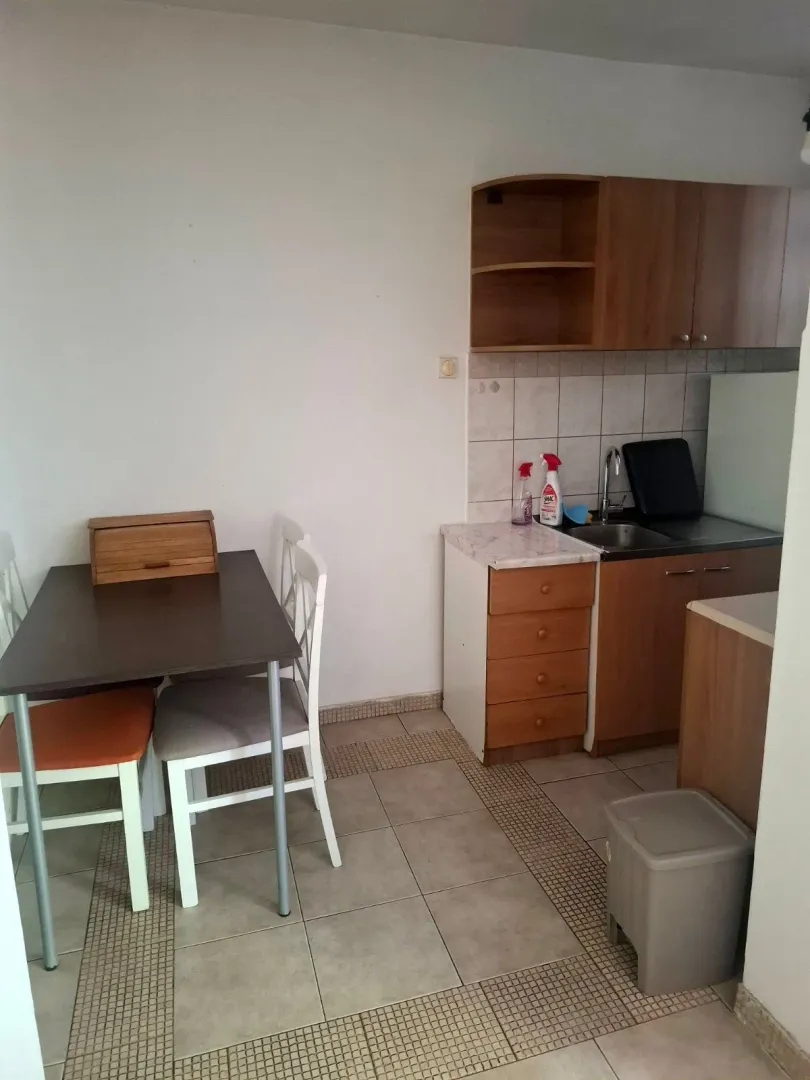 Small kitchen with a dining table and chairs.