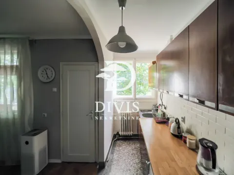 Small kitchen with wooden units and built-in kitchen appliances. - image 13