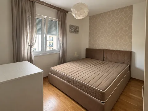 Furnished bedroom with a double bed, window, and hardwood flooring. - image 9
