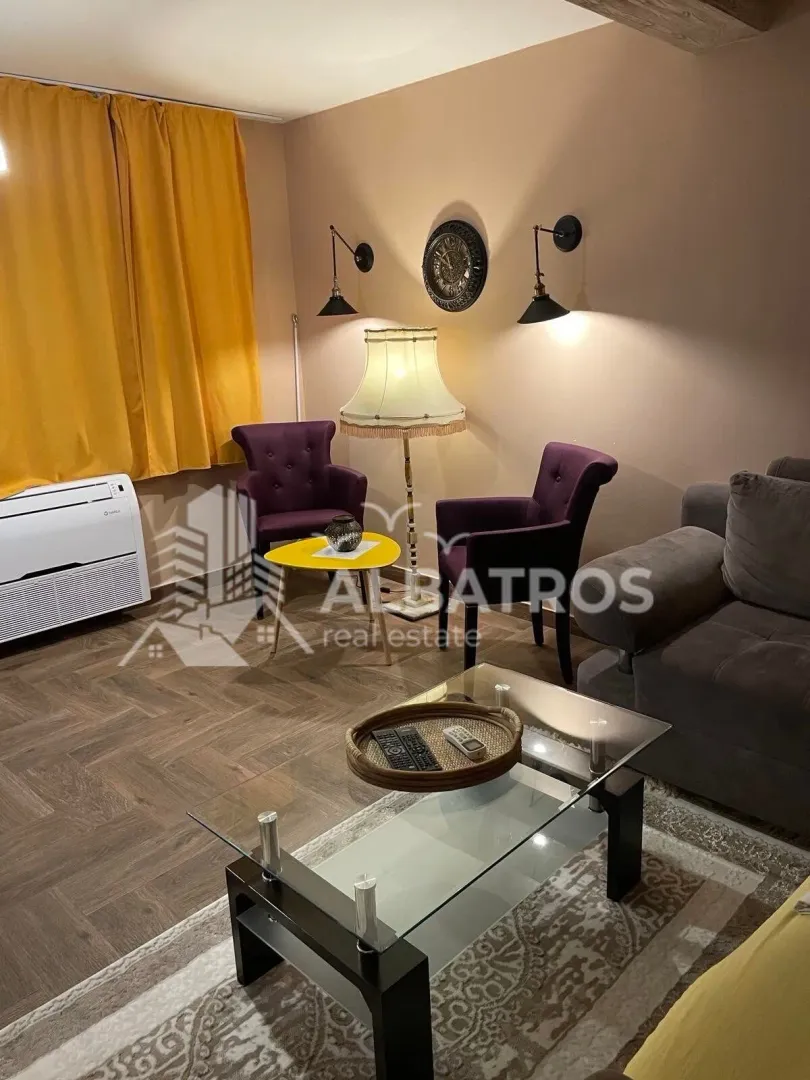 Living room with a sofa, armchairs, and a coffee table.