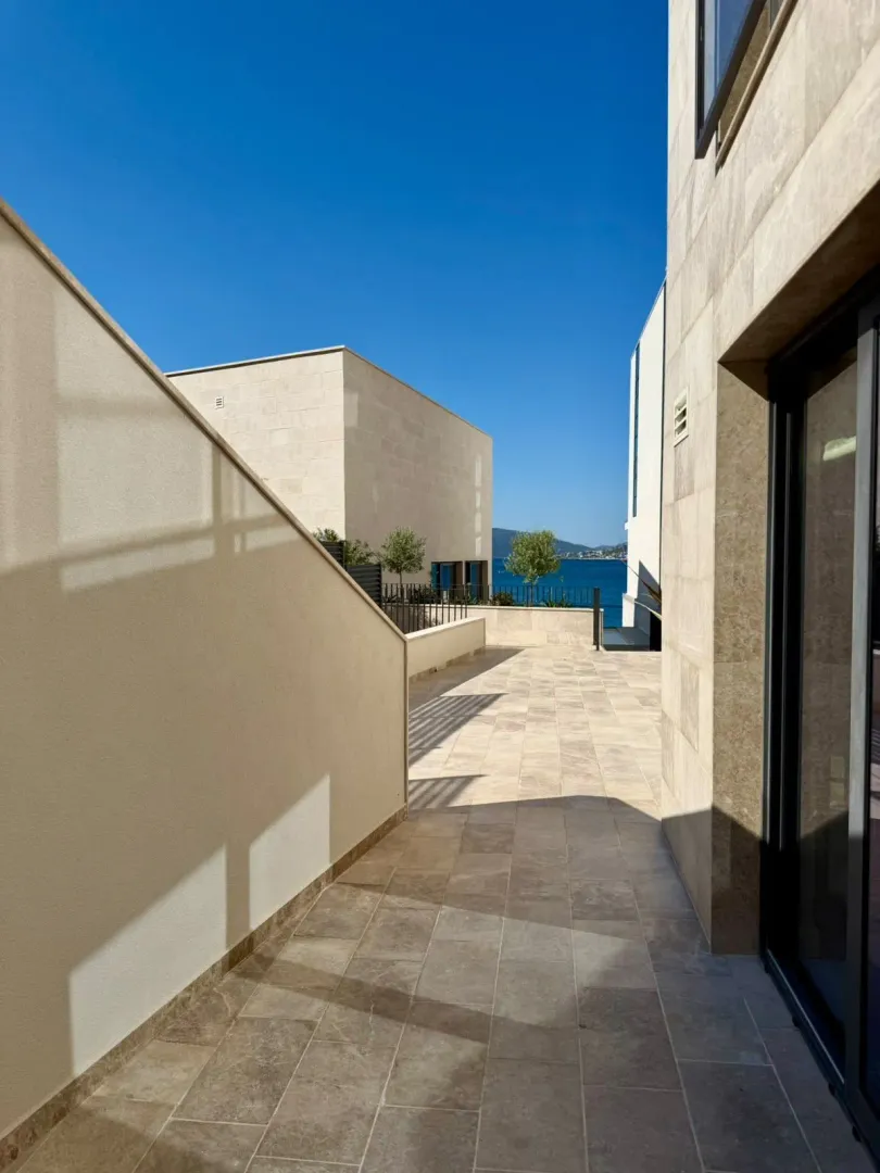 Paved terrace of a modern building with a sea view.