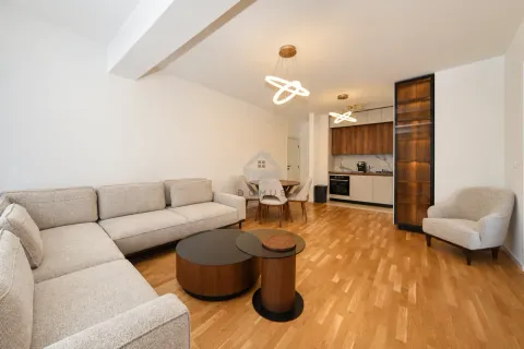 Modern living room with sofa, dining area, and fitted kitchen. - image 3