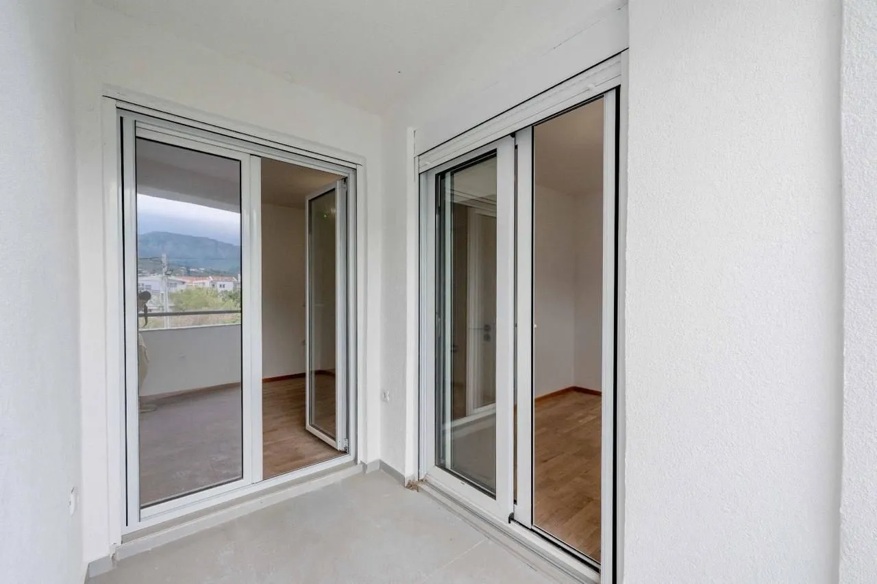 View of a covered terrace with white window frames.