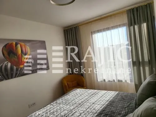 Furnished bedroom with a double bed and a window.