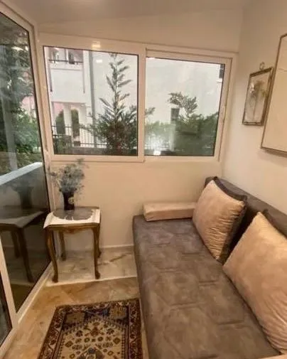 Small lit living room with a sofa seating set and an exterior view.