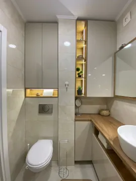 Modern bathroom with built-in cabinetry, washbasin, and toilet. - image 8