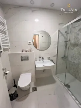Modern bathroom equipped with a walk-in shower and marble tiles. - image 7