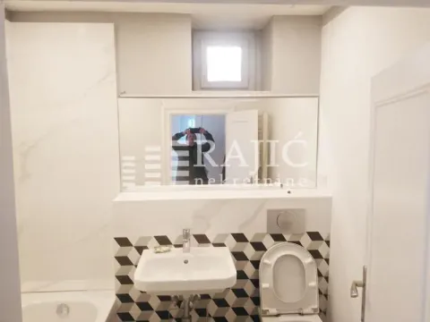 Small bathroom with a sink, toilet, and mirror. - image 18