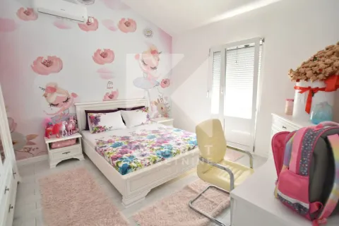 Children's bedroom with a double bed, desk, and wallpaper featuring floral and ballerina motifs. - image 19