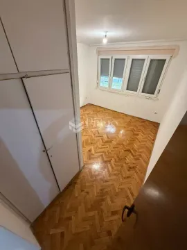 Empty room with parquet flooring and a built-in wardrobe. - image 4