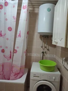 Part of a bathroom with a bathtub, washing machine, and boiler. - image 7