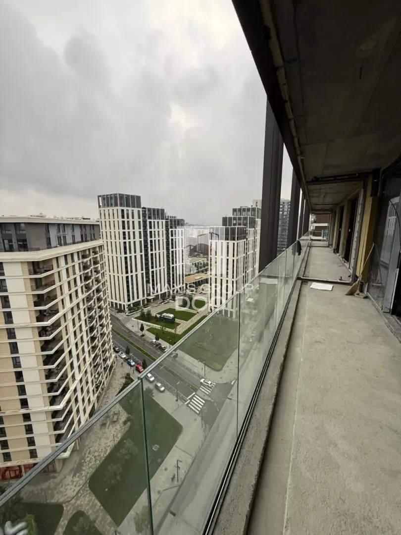 View from the balcony under construction towards surrounding buildings and neighborhood.