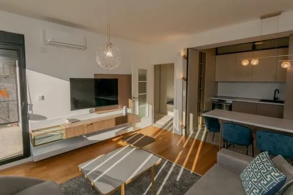 Modern living room with dining area and kitchen in an open-plan space.