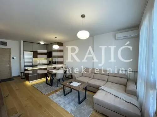 Spacious living room connected to the dining area and modern kitchen.
