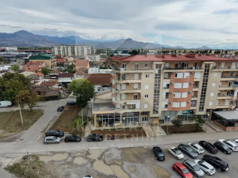 Aerial view of the residential building and surroundings with parking. - image 9