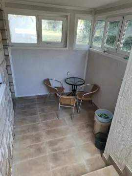 Enclosed terrace with seating furniture and tiled flooring. - image 6