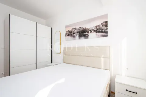 Bright bedroom with a double bed, white wardrobe and nightstands. - image 5
