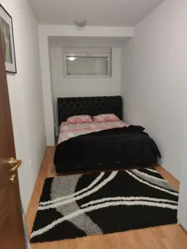 Small bedroom with a double bed and a rug. - image 14