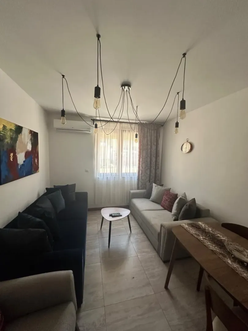 Spacious living room with seating furniture and a dining table.