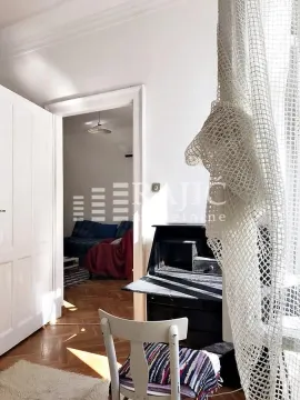 View from the room towards the dining area with a desk and a white chair. - image 10