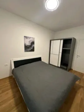 Furnished bedroom with a double bed and a wardrobe. - image 3