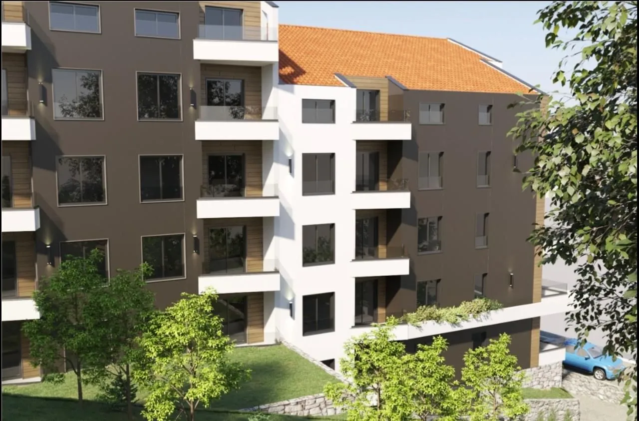 Prikaz eksterijera moderne stambene zgrade sa terasam i uređenim dvorištem.