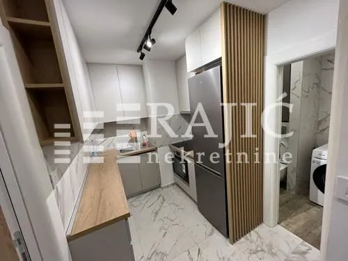 Modern and bright kitchen with built-in appliances and wooden details.