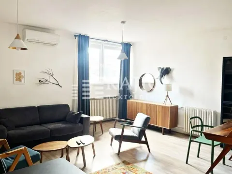 Bright living room furnished with a sofa, armchair, and dining table. - image 16