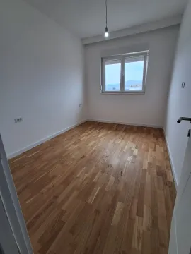 Empty room with hardwood flooring and white walls. - image 4