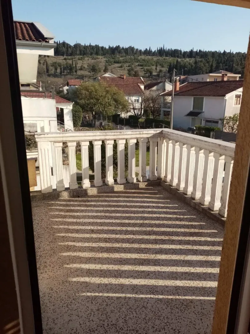 View from a terrace with a concrete railing overlooking the neighborhood.