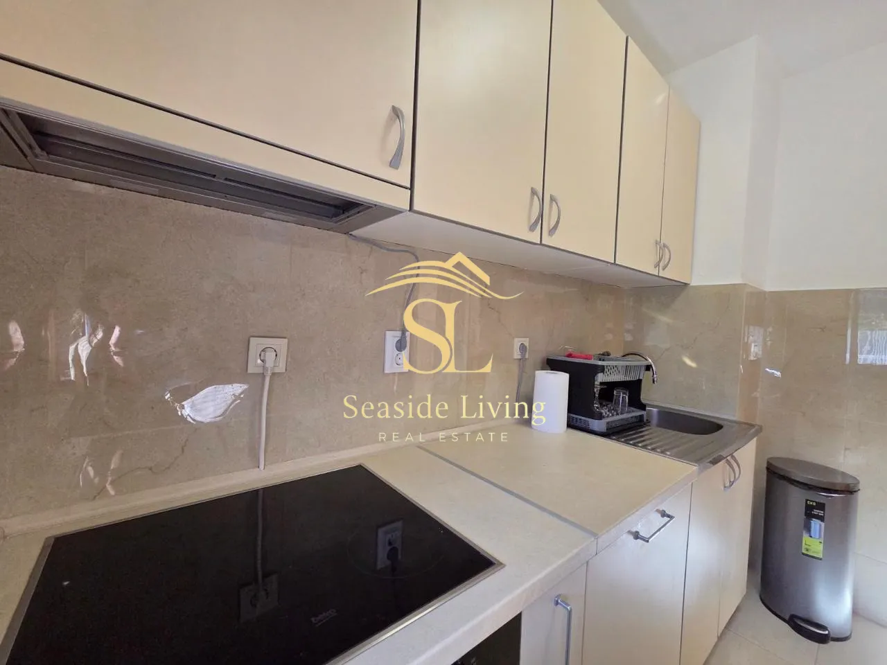 Small kitchen with built-in cabinetry and appliances.