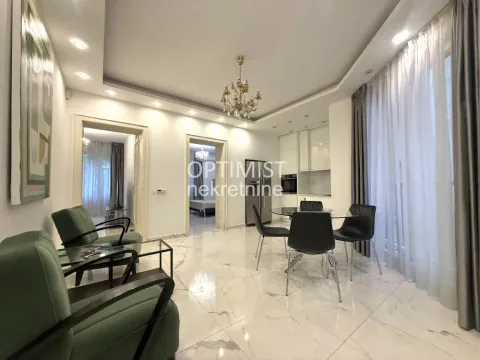 Spacious living room with a dining area and kitchen in the background. - image 2
