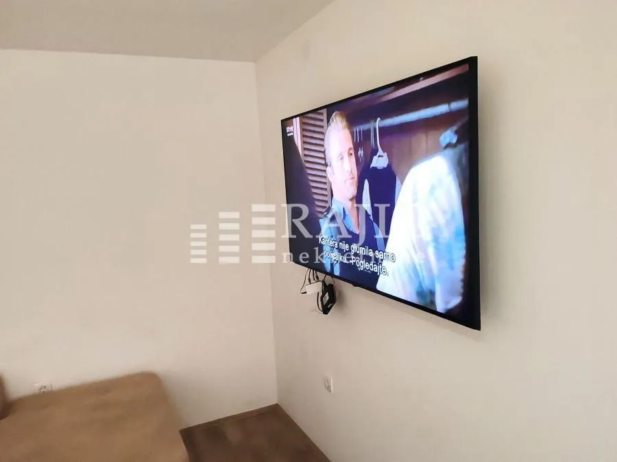 Living room with a wall-mounted TV.