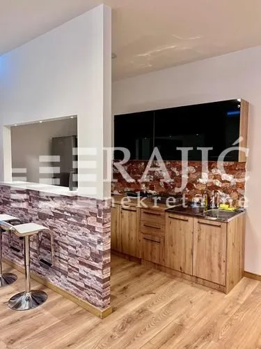 Modern kitchen with a breakfast bar and dining area.