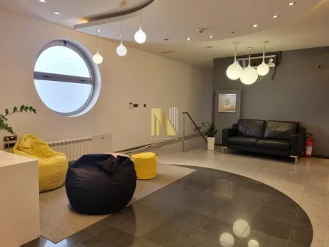 Spacious living room with modern furniture and a round window. - image 7