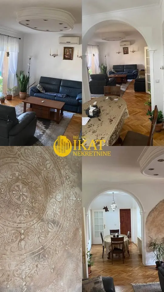 Pregled delova dnevne sobe i trpezarije sa parketom i ukrasnim plafonom.