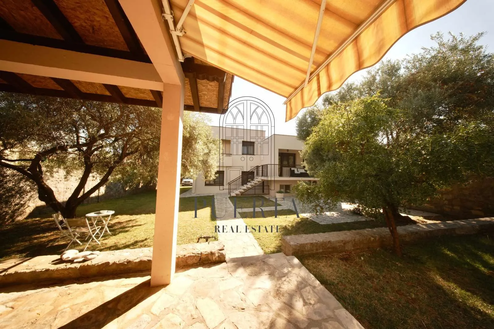 View of the house and green garden from the yard.