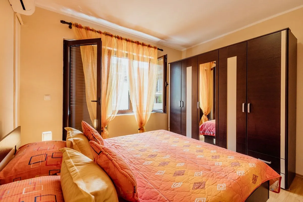 Furnished bedroom with a double bed, large wardrobe, and access to the terrace.