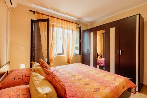 Furnished bedroom with a double bed, large wardrobe, and access to the terrace. - image 7