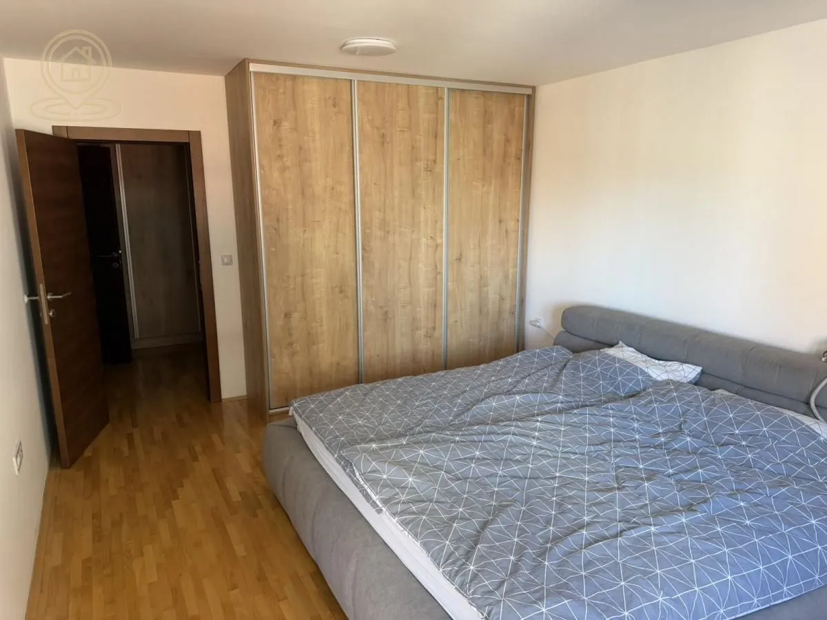 Bedroom with a large double bed and a fitted wardrobe.