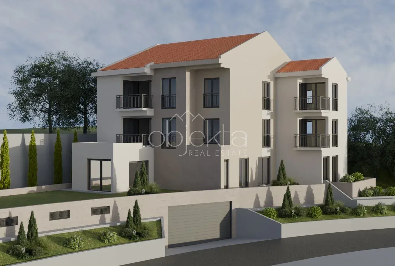 Spoljašnji izgled moderne stambene zgrade sa uređenim dvorištem i garažom.