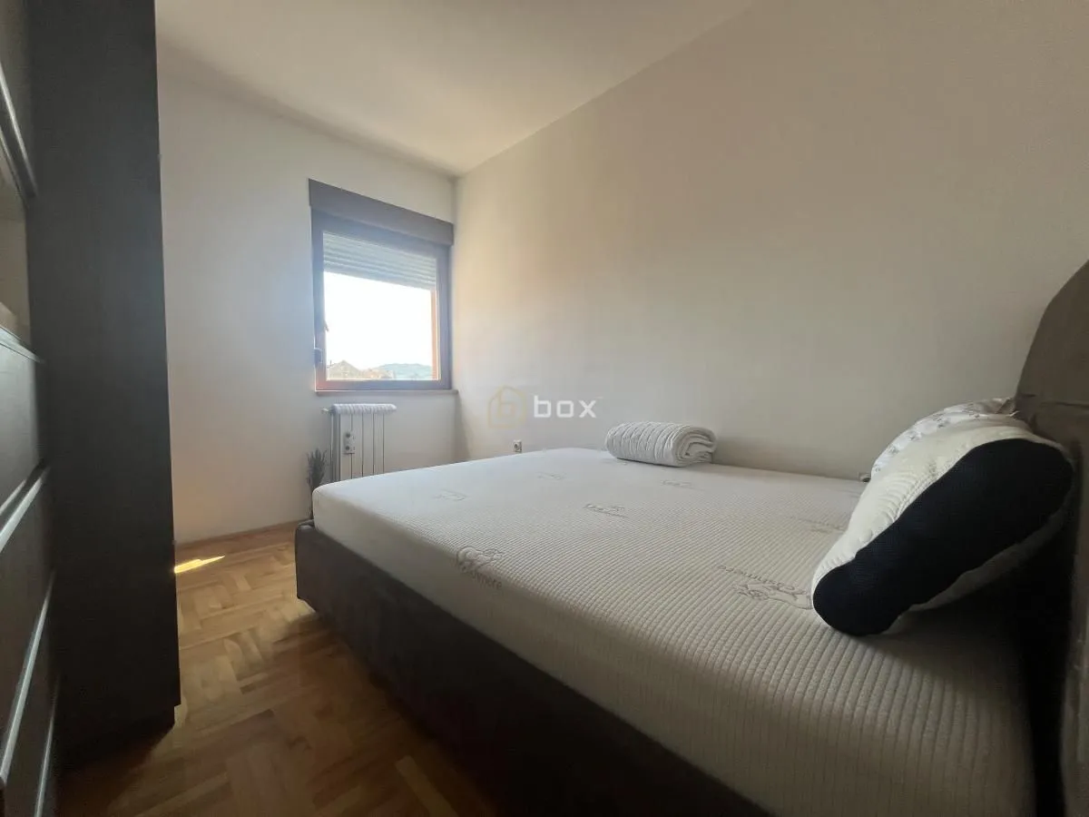 Bedroom with a double bed and a window.