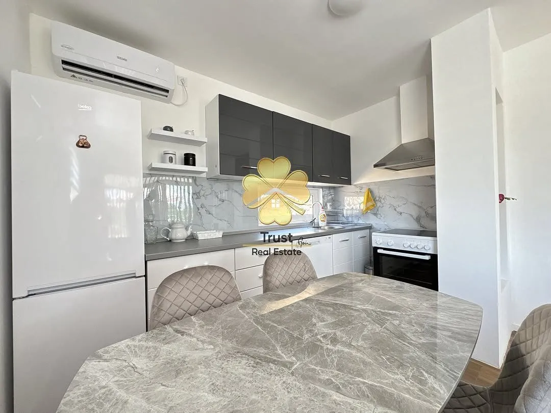 Modern kitchen with a dining table and built-in appliances.