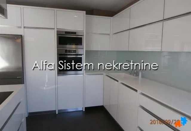 Modern white kitchen with built-in appliances.
