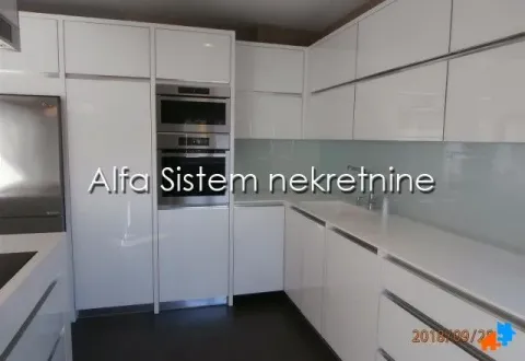 Modern white kitchen with built-in appliances. - image 8