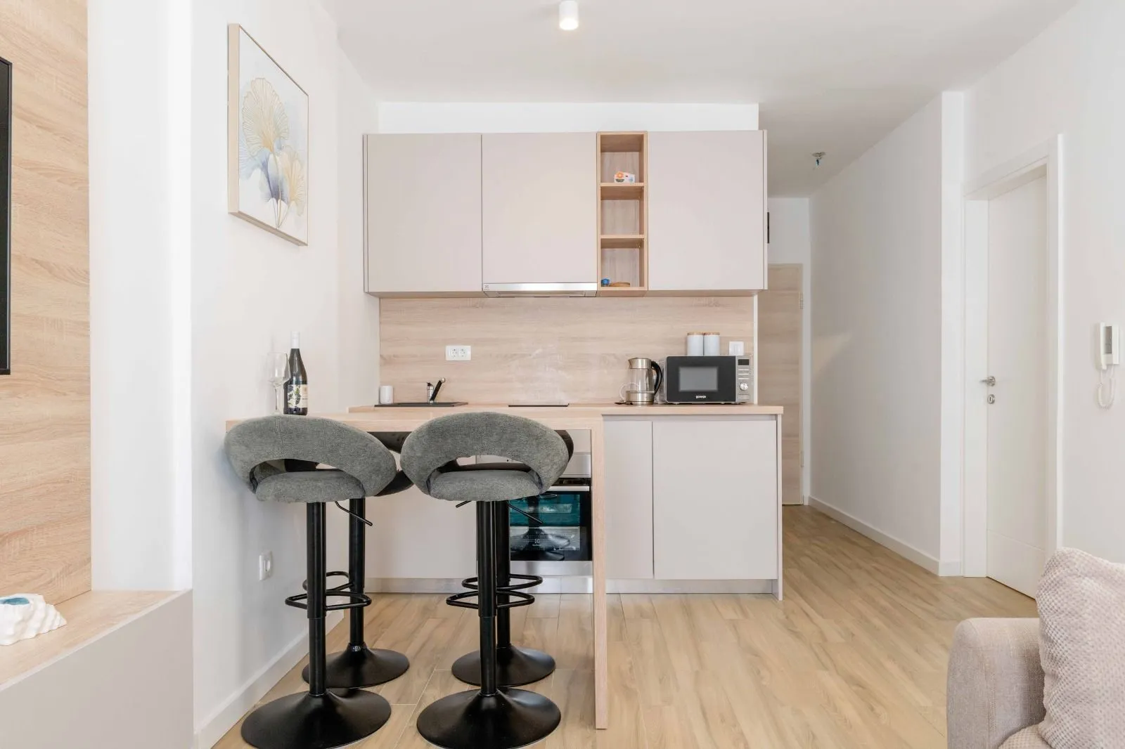 Small modern kitchen with a breakfast bar and bar stools.