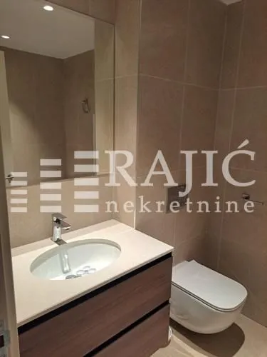 Modern bathroom with a sink and toilet.